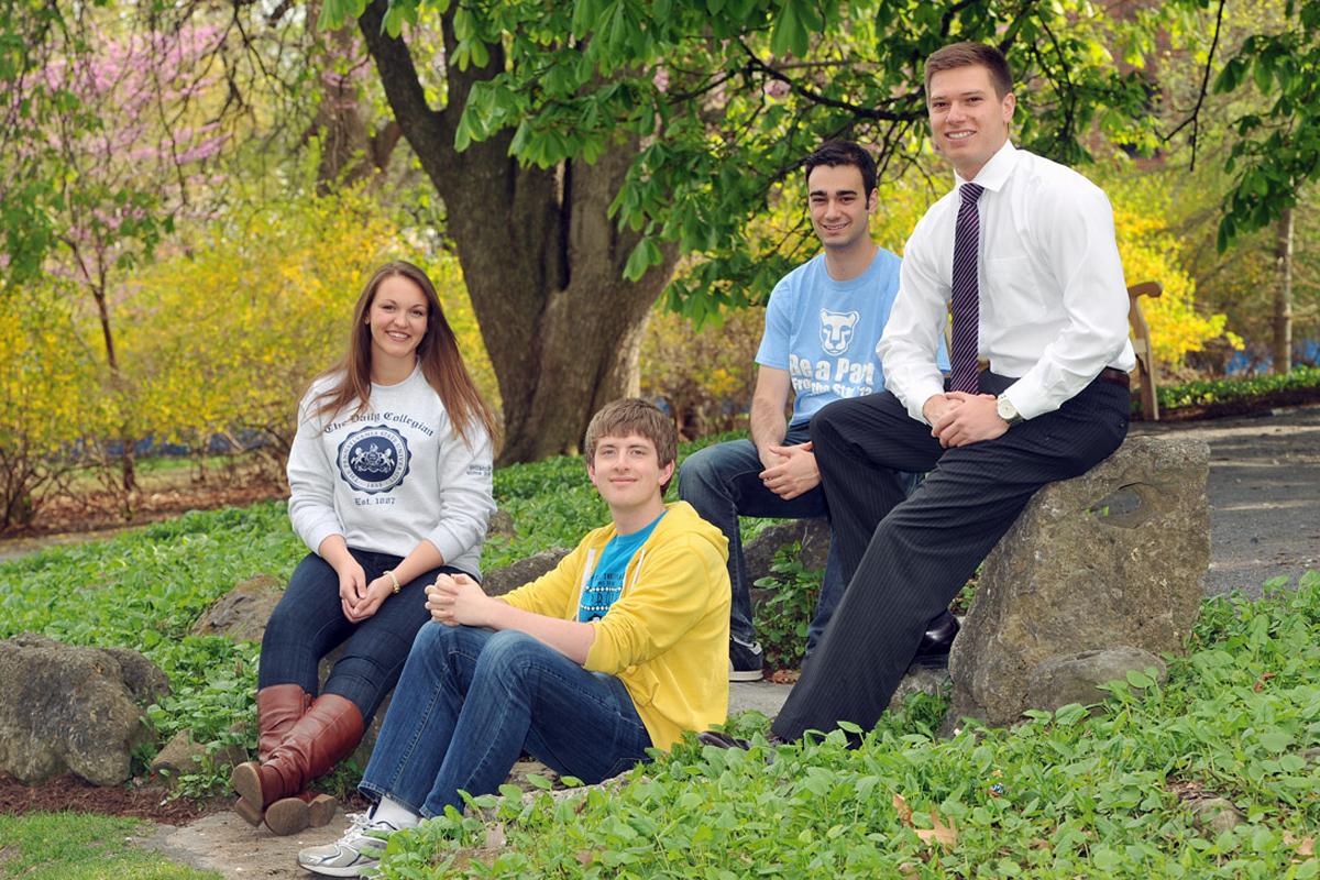 Schreyer Honors College Living & Learning Environment 4 students sitting on rocks